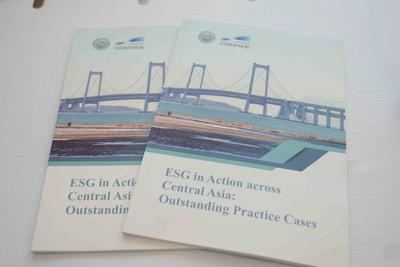 The photo shows the cover of the casebook titled 'ESG in Action across Central Asia: Outstanding Practice Cases.'