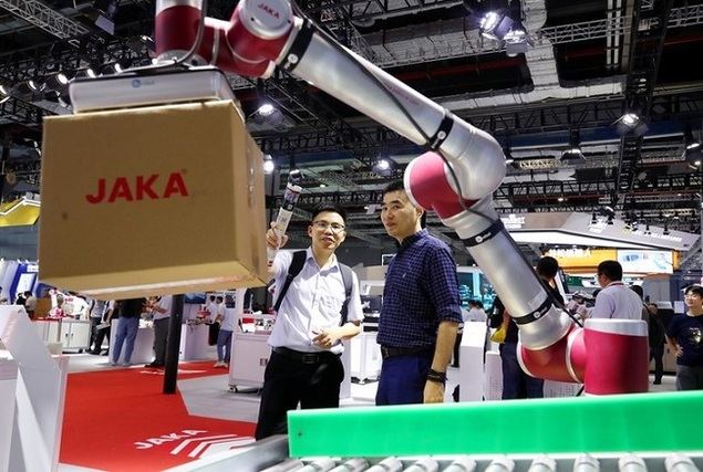 Visitantes observan a un robot trasladar una caja durante la 23ª Feria Internacional de la Industria de China (CIIF, por sus siglas en inglés), en Shanghai, en el este de China, el 19 de septiembre de 2023. (Xinhua/Fang Zhe)